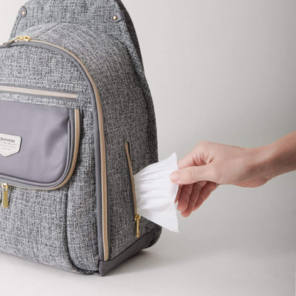 Person taking a wipe from Sunveno Tweed Luxe Diaper Bag Backpack - Gray on a light gray background