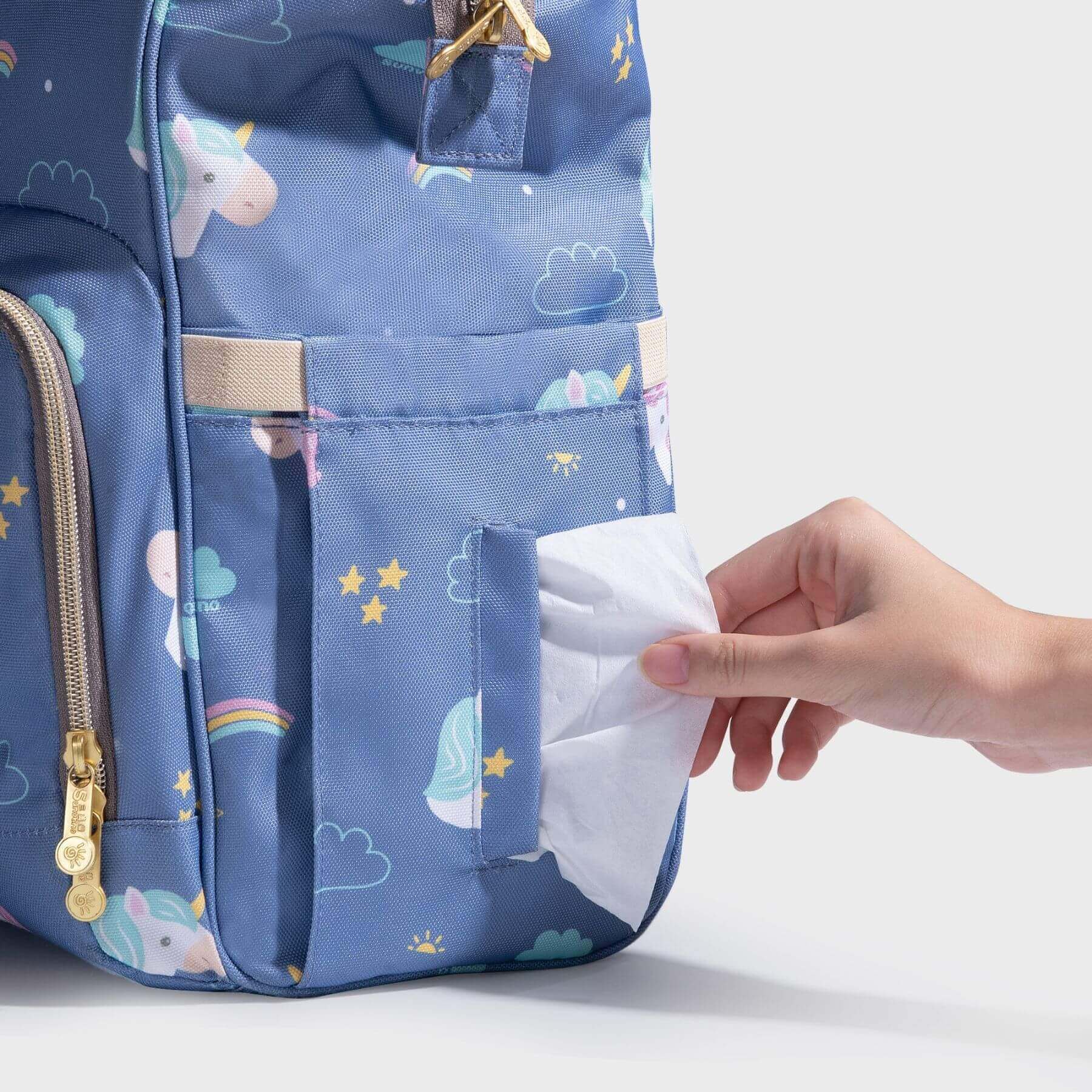 Hand reaching tissue in Sunveno Timeless Baby Diaper Backpack - Blue Unicorn