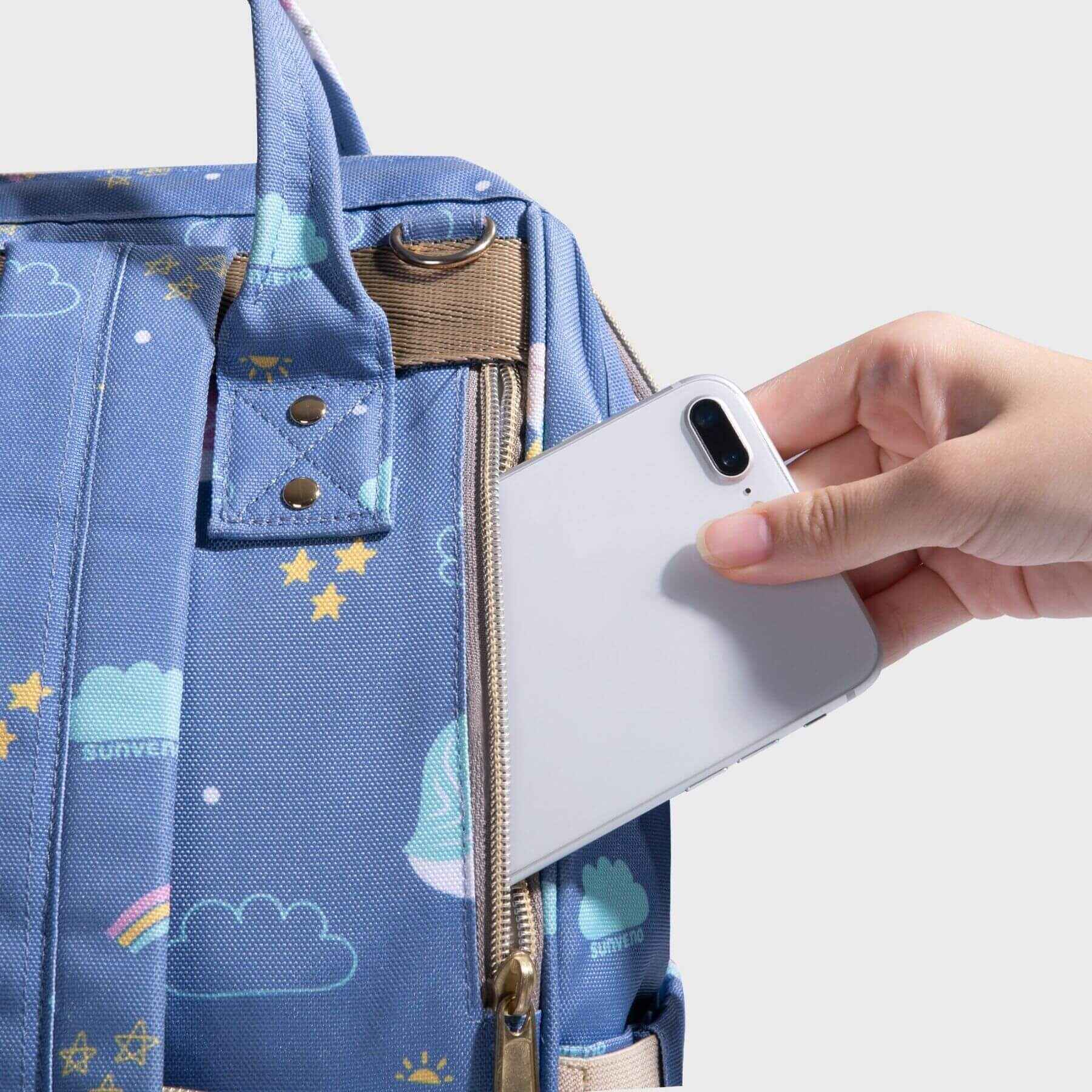 Hand put a phone in Sunveno Timeless Baby Diaper Backpack - Blue Unicorn