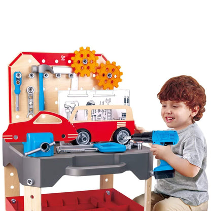 Child playing with Hape Vehicle Service & Repair Workbench