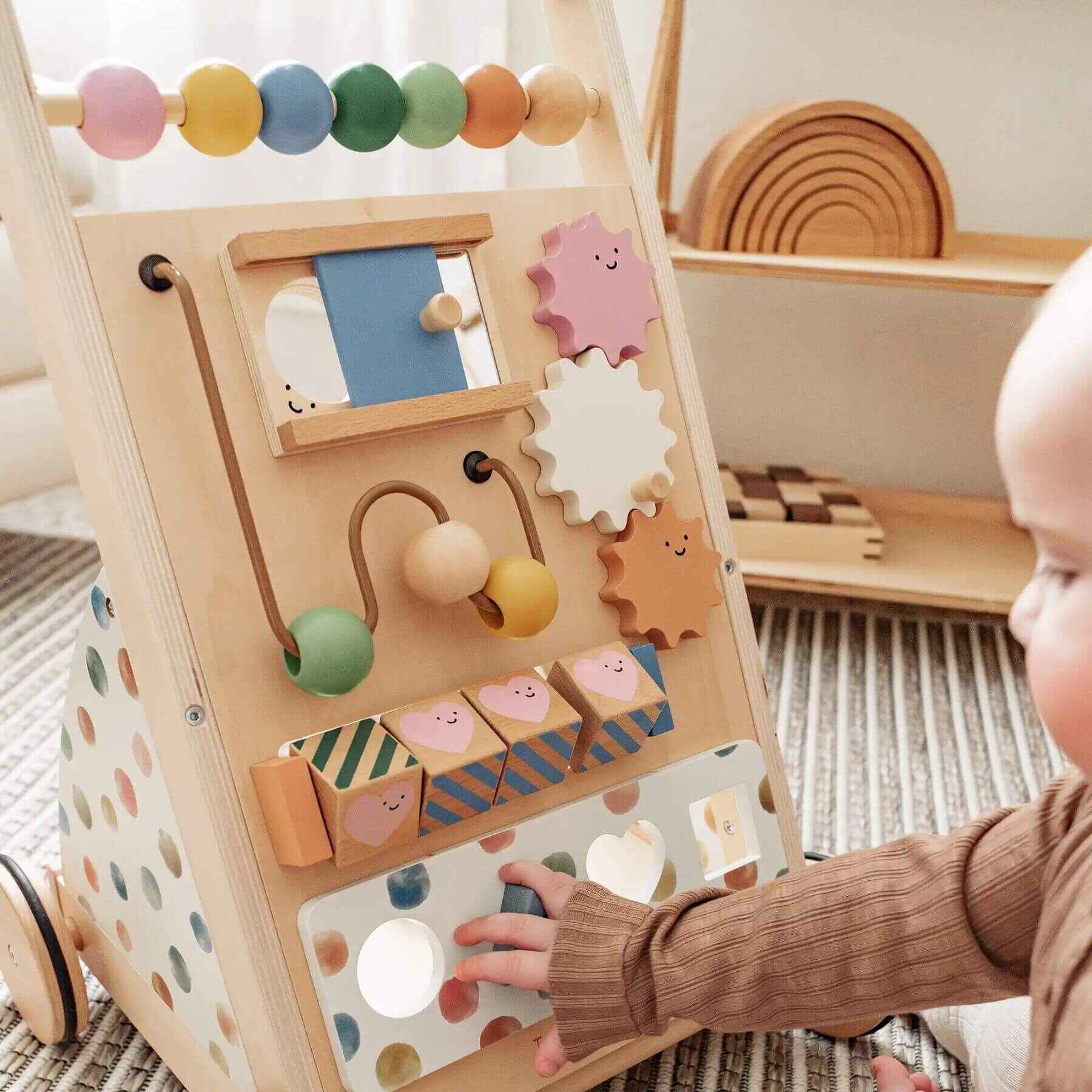 Child playing with Tiny Land® Versatile Natural Wooden Baby Walker on a carpeted floor