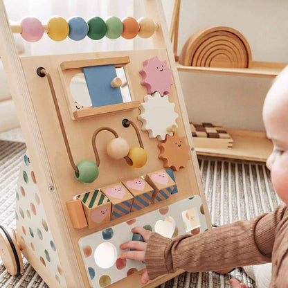 Child playing with Tiny Land® Versatile Natural Wooden Baby Walker on a carpeted floor