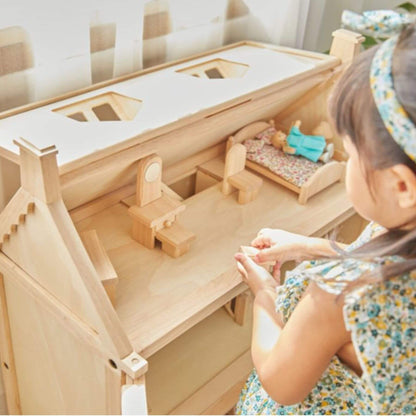 Child playing with PlanToys Victorian Dollhouse