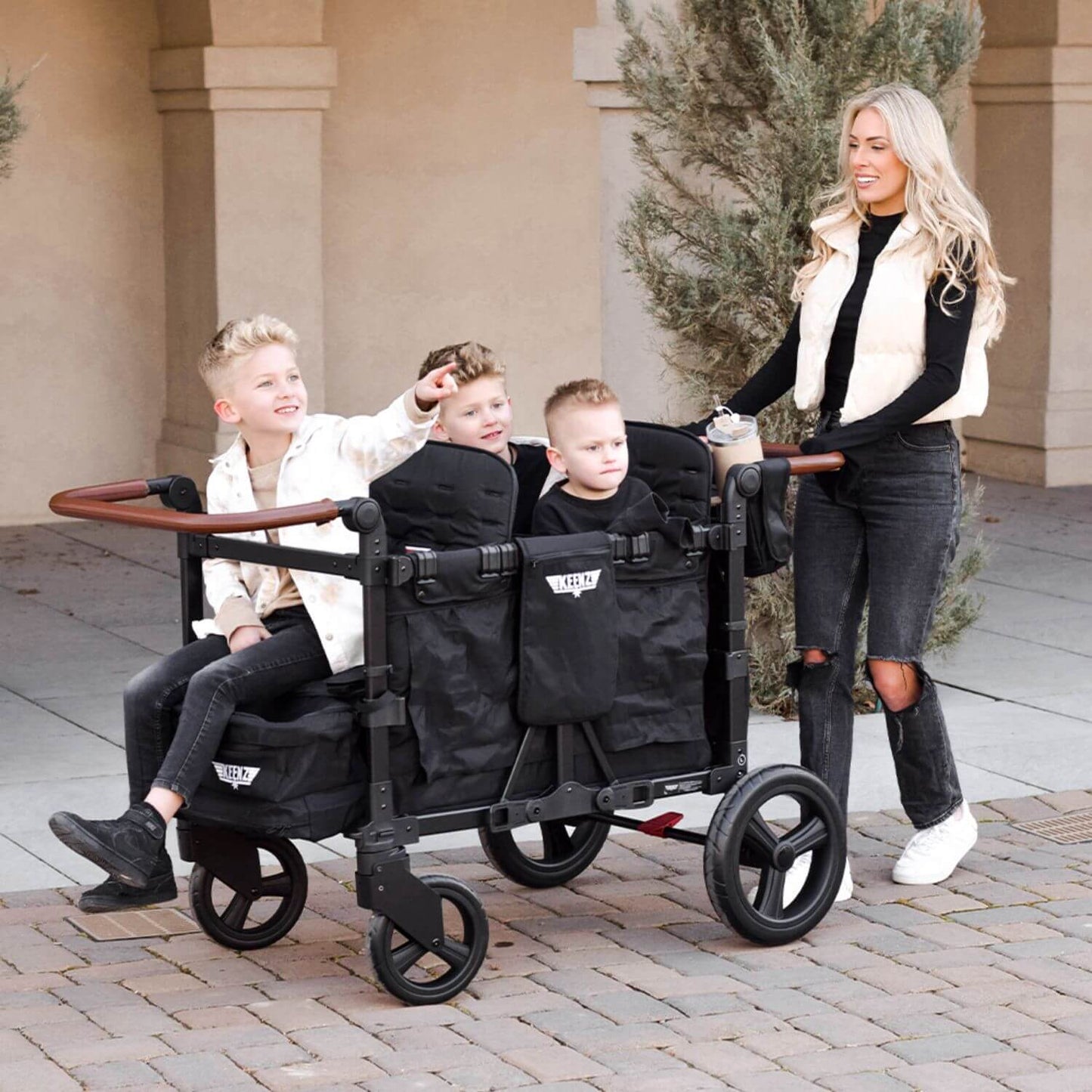 Mom Pushing Kids w/ Keenz Vyo͞o The Seating Chameleon Stroller Wagon 4-Passengers Black