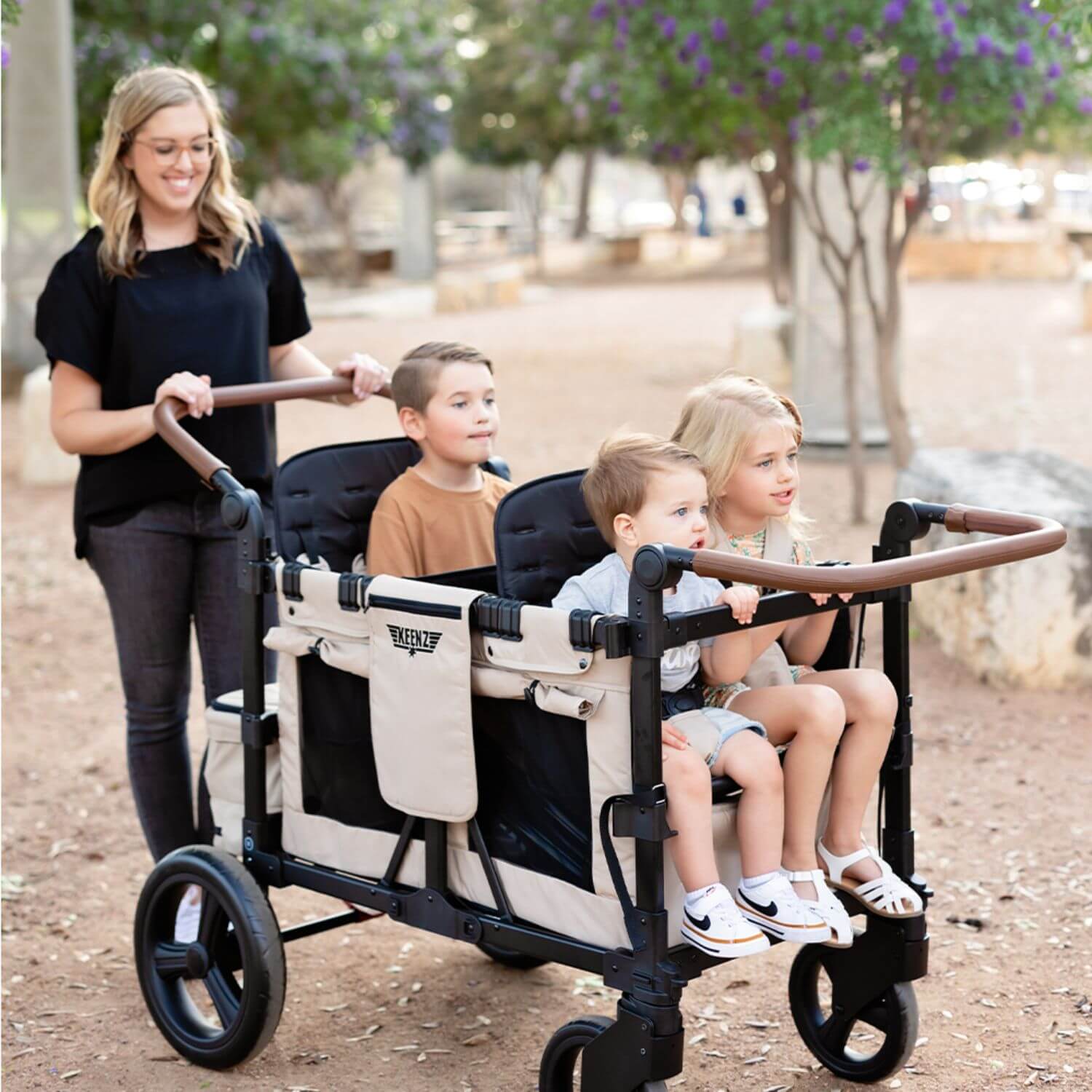 Mom Pushing Kids in Keenz Vyo͞o The Seating Chameleon Stroller Wagon 4-Passengers Grey