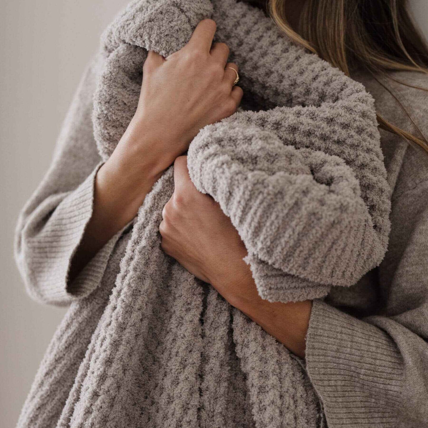 Person holding Saranoni Waffle Knit XL Throw Blanket - Oatmeal