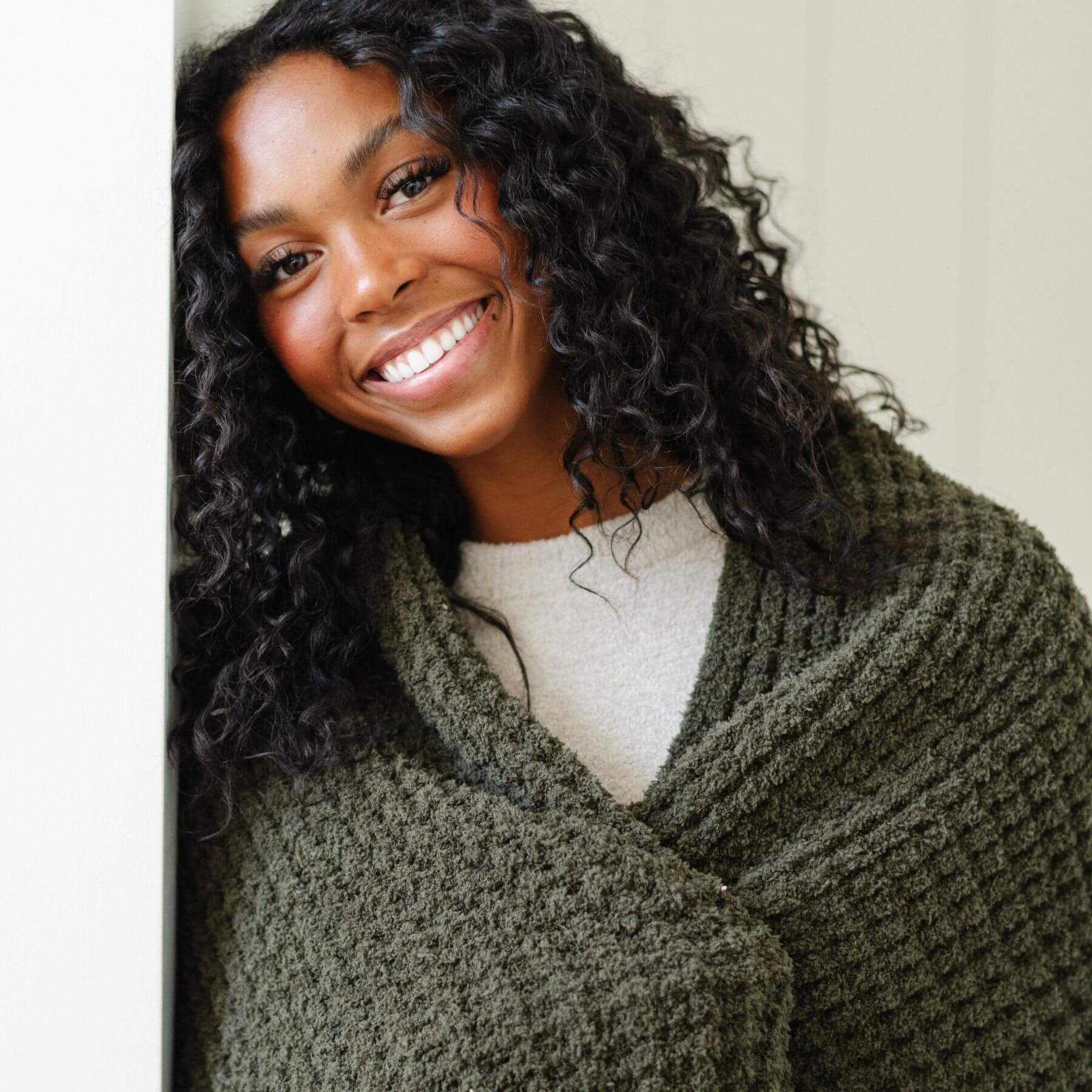 Woman wearing Saranoni Waffle Knit XL Throw Blanket - Thyme