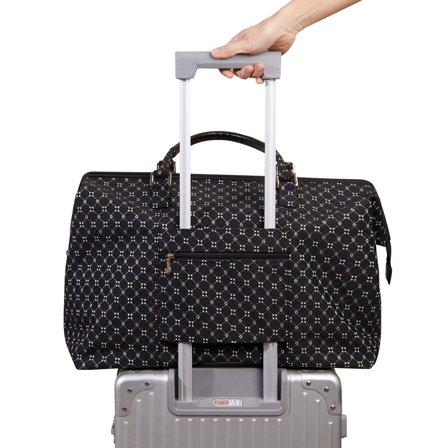 Sunveno Weekender Mommy Bag Travel Duffle - Black on luggage with a hand holding onto its handle