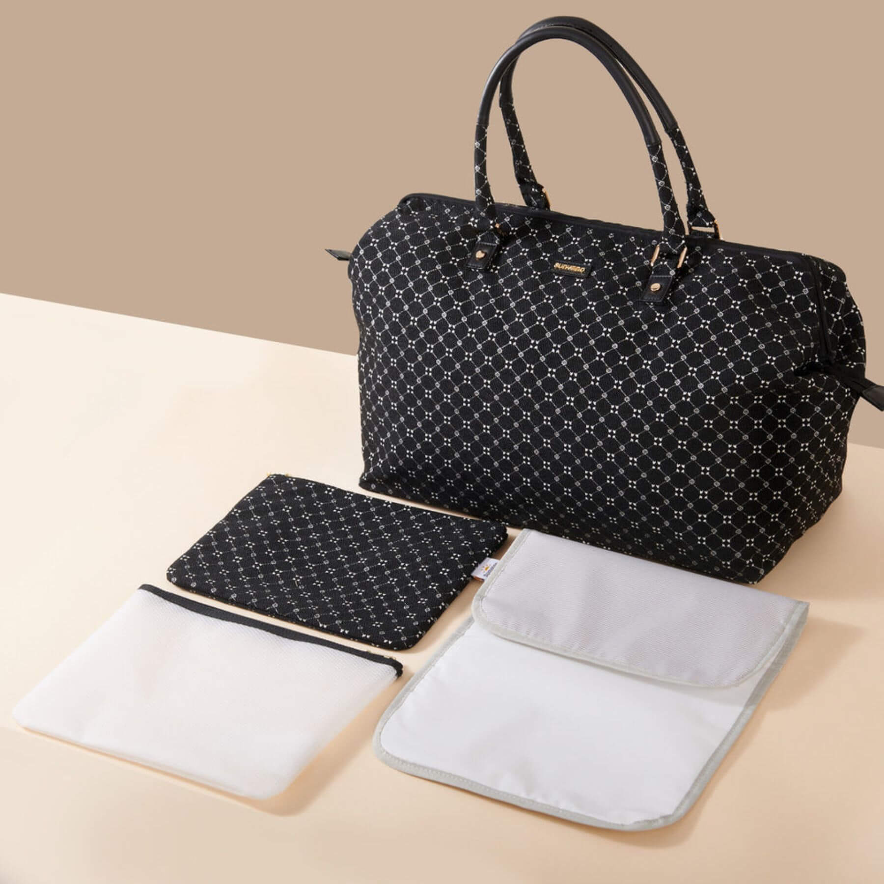 Sunveno Weekender Mommy Bag Travel Duffle - Black Classic with white changing pad and pouch on a beige background