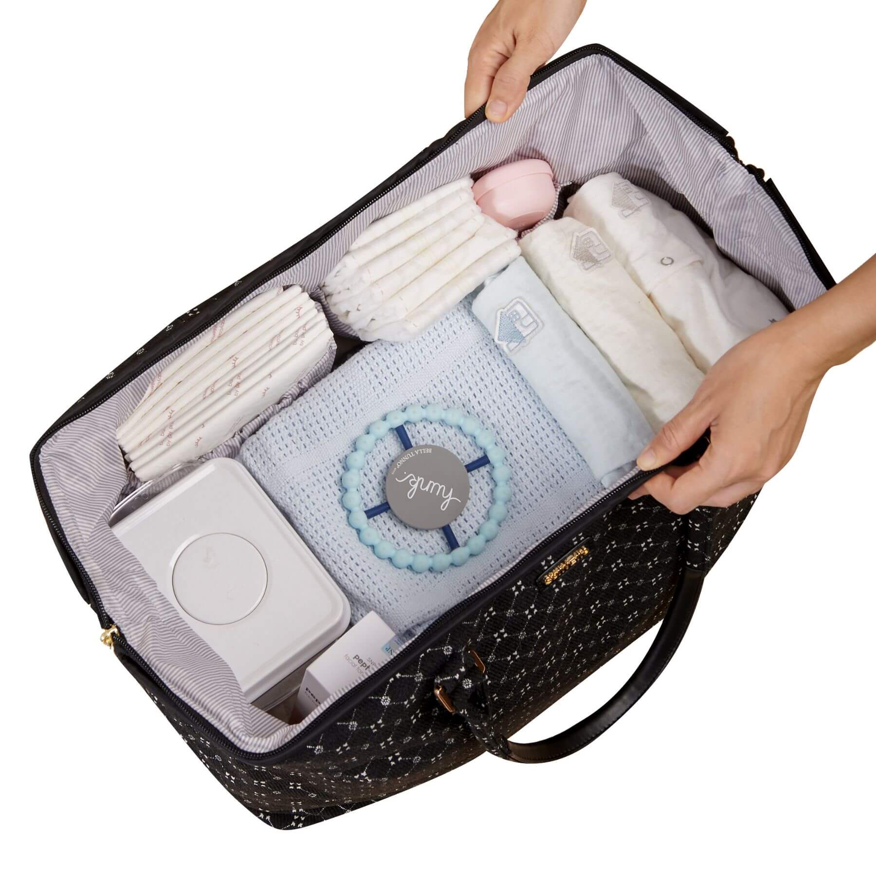 Open Sunveno Weekender Mommy Bag Travel Duffle - Black Classic with baby items including blankets and a toy, held by two hands