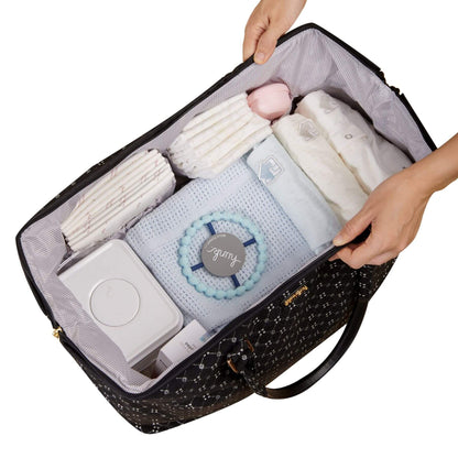 Open Sunveno Weekender Mommy Bag Travel Duffle - Black Classic with baby items including blankets and a toy, held by two hands