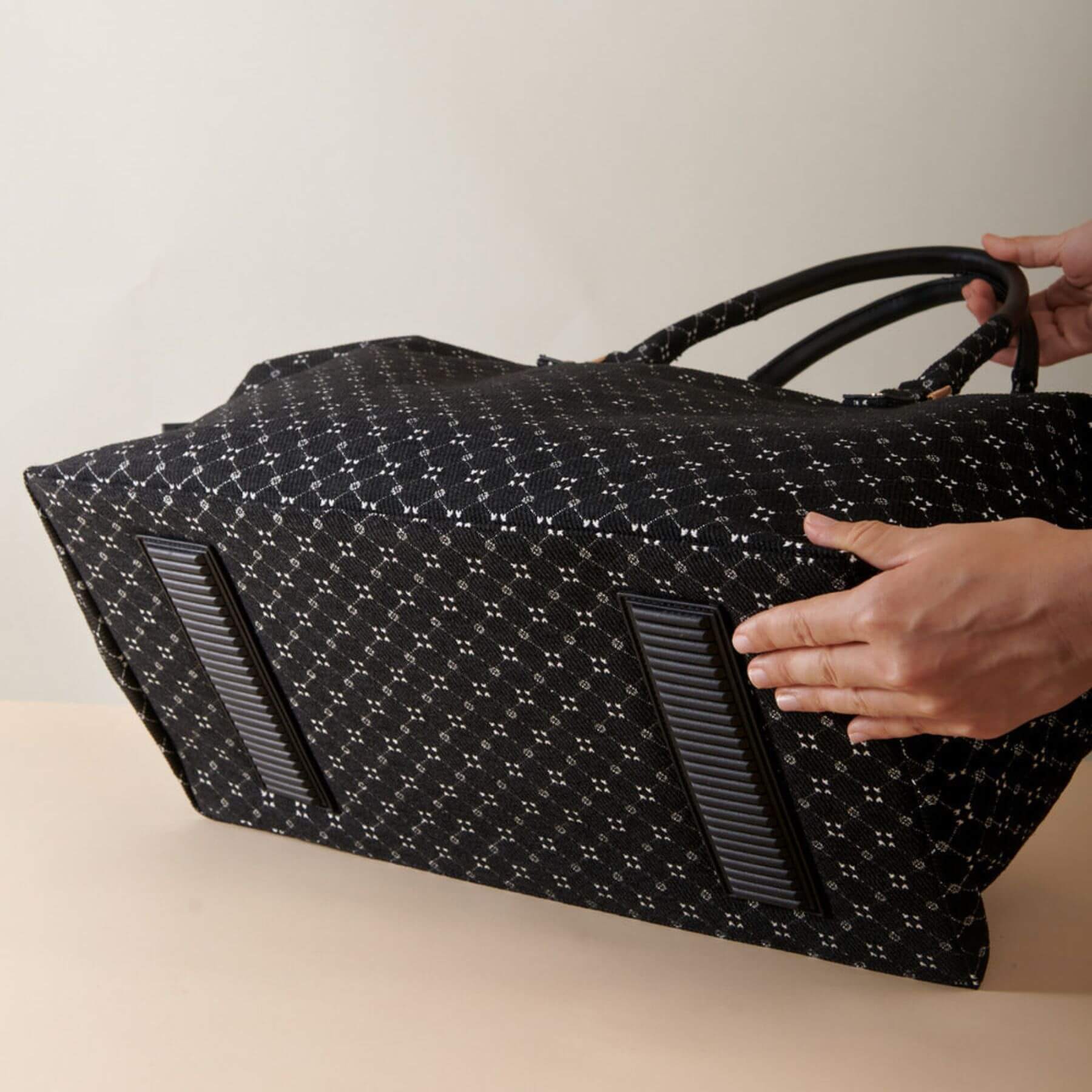 Sunveno Weekender Mommy Bag Travel Duffle - Black Classic held by a person against a neutral background