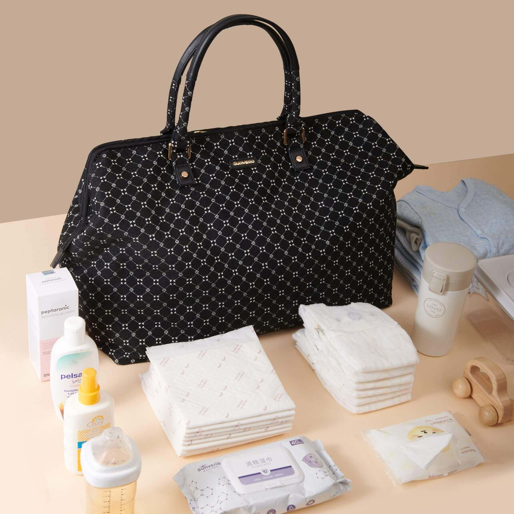 Sunveno Weekender Mommy Bag Travel Duffle - Black Classic with baby care items on a beige surface