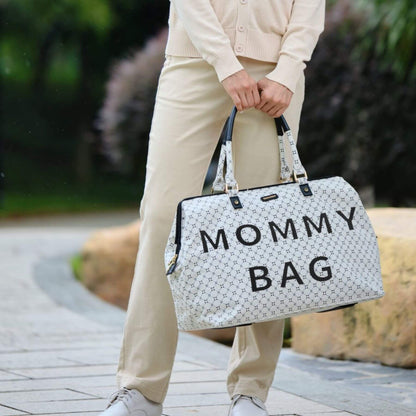 Person holding Sunveno Weekender Mommy Bag Travel Duffle - White outdoors.