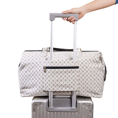Sunveno Weekender Mommy Bag Travel Duffle - White being pulled on a suitcase with a hand visible.
