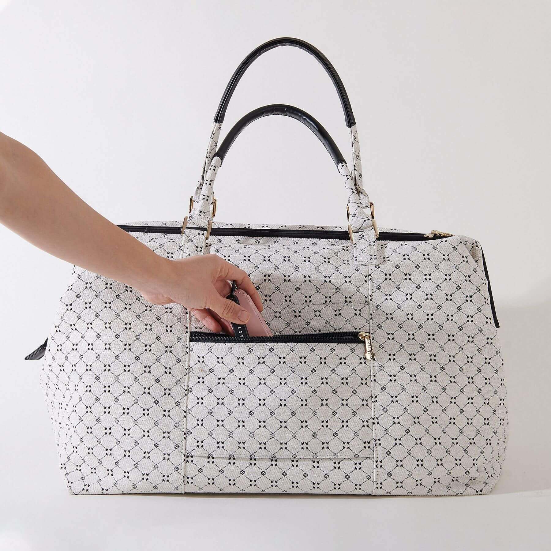 Sunveno Weekender Mommy Bag Travel Duffle - White with a hand reaching to open it