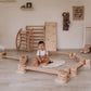 Boy Sitting on Playmat next to Wood and Hearts Balance Beam Zigzag