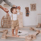 Parent Holding Boy Playing Wood and Hearts Balance Beam Zigzag