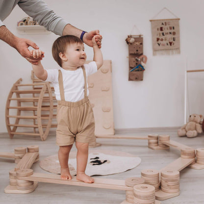 Parent Holding Boy Playing Wood and Hearts Balance Beam Zigzag