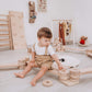 Boy Sitting on Wood and Hearts Balance Beam Zigzag