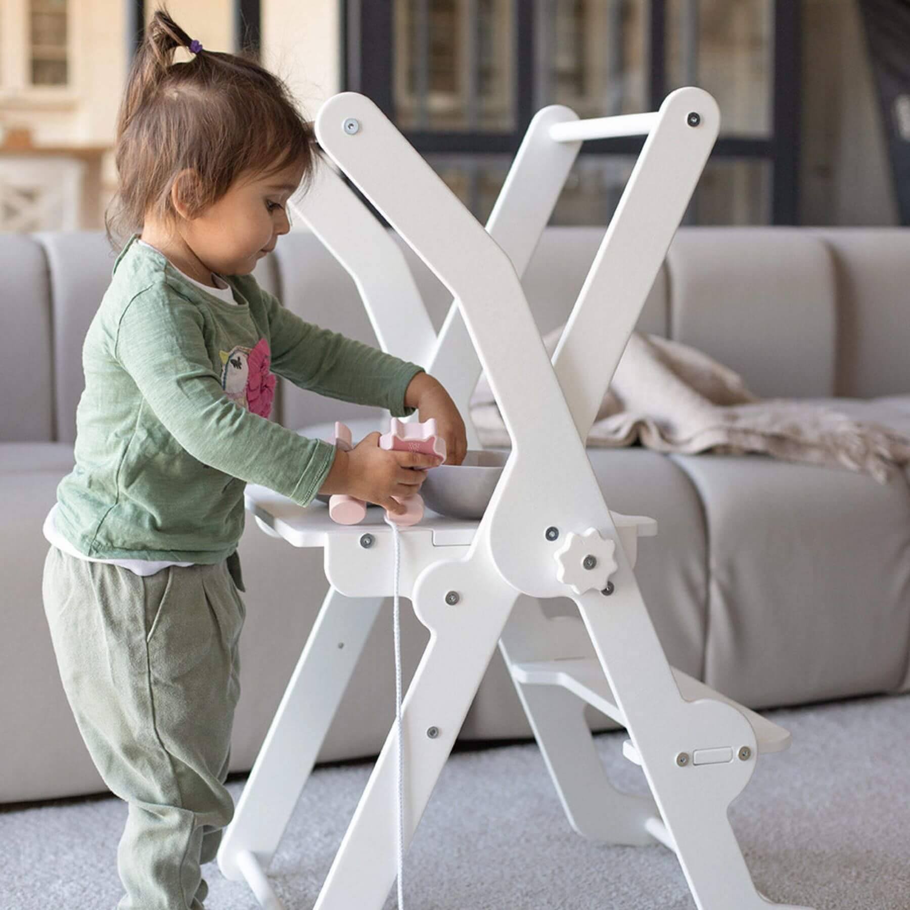 Girl Playing at Wood and Hearts Foldable Kitchen Tower