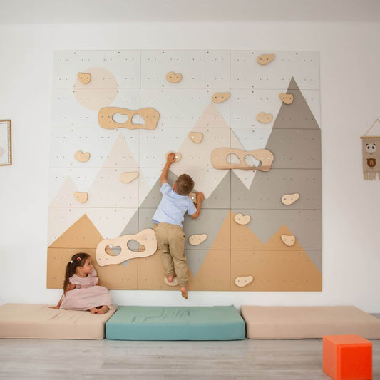 Children playing on Wood and Hearts Indoor Climbing Wall in a room.