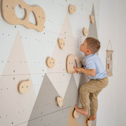 Child climbing on Wood and Hearts Indoor Climbing Wall