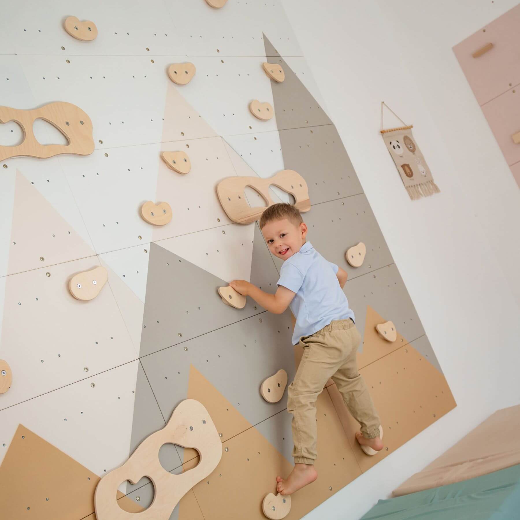 Child climbing on Wood and Hearts Indoor Climbing Wall