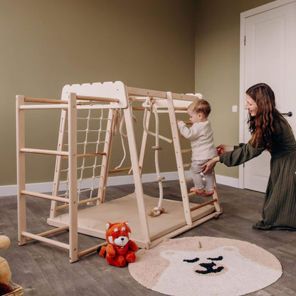 Mom Holding Baby Climbing on Wood and Hearts Indoor Jungle Gym - Trapeze + Ladder + Mat + Rope