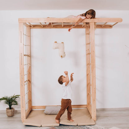Two children playing on Wood and Hearts Indoor Monkey Bars - Natural in a minimalistic room.