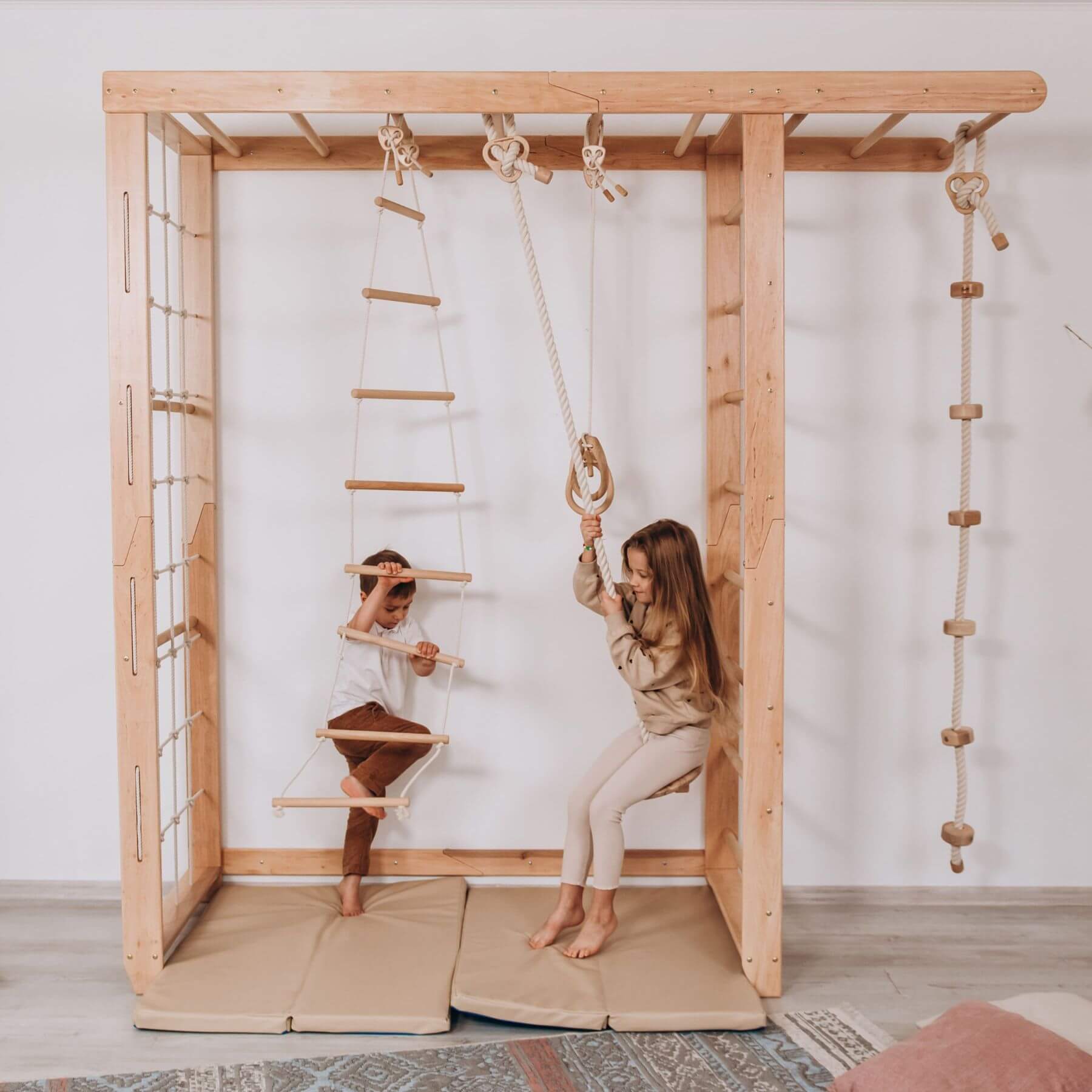 Two children playing on Wood and Hearts Indoor Monkey Bars - Natural