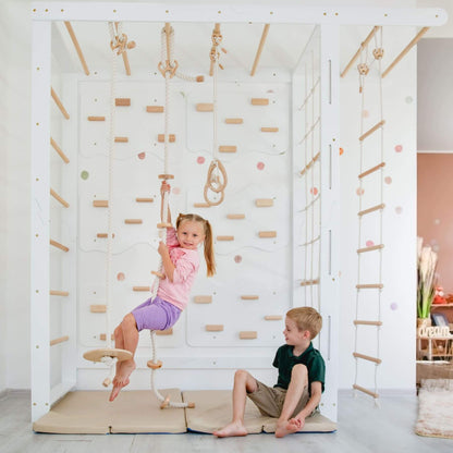 Two children playing on Wood and Hearts Indoor Monkey Bars - White indoors.