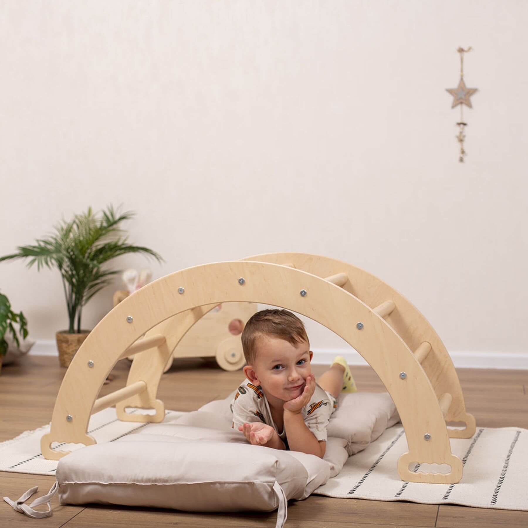 Boy Lying on Pillow Sandy Bay, Under Wood and Hearts Large Climbing Arch