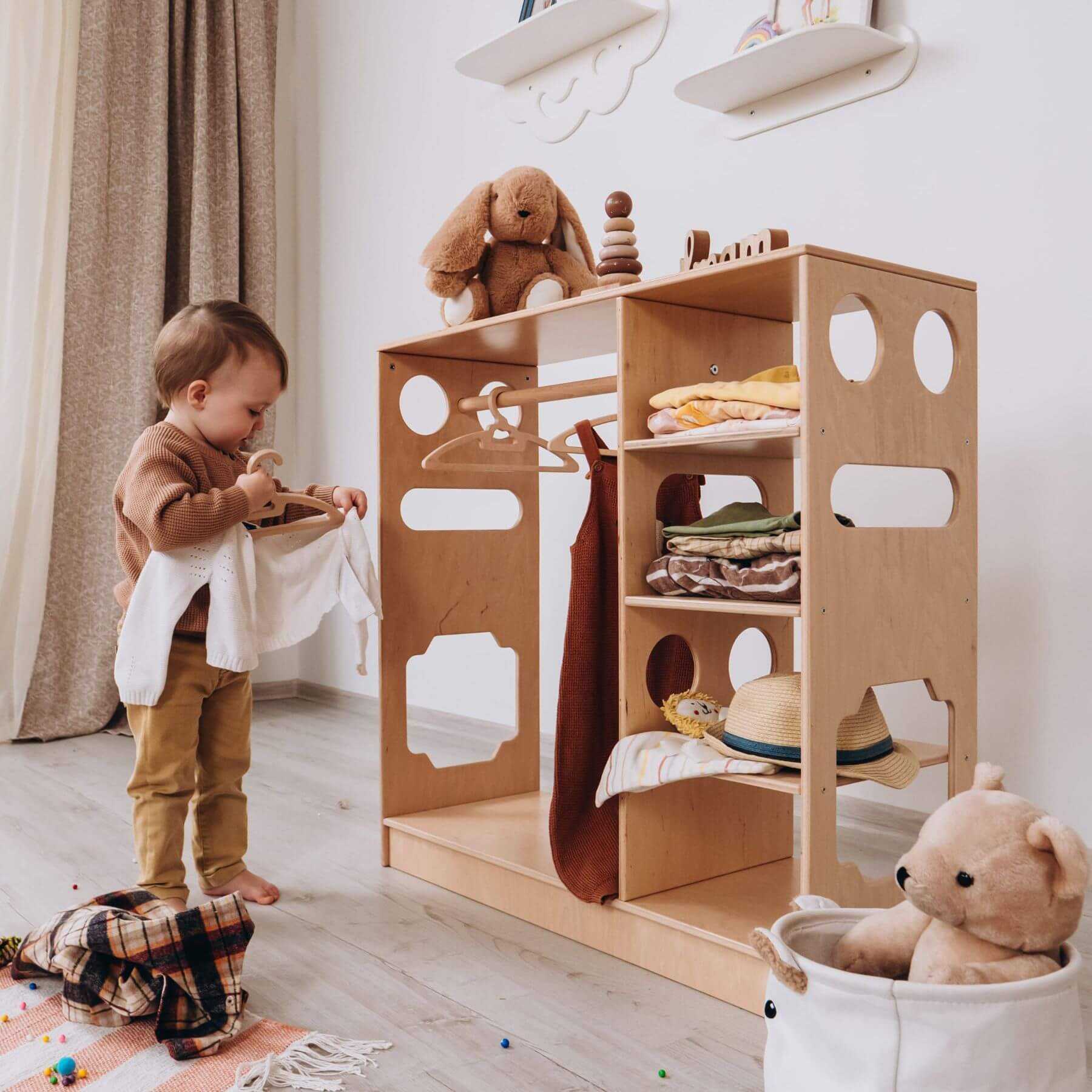 Boy Hanging Cloth to Wood and Hearts Montessori Closet