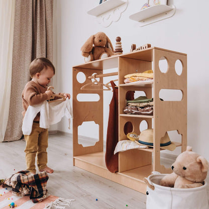 Boy Hanging Cloth to Wood and Hearts Montessori Closet