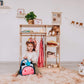 Girl Sitting on the Base of Wood and Hearts Montessori Closet Champion Plus