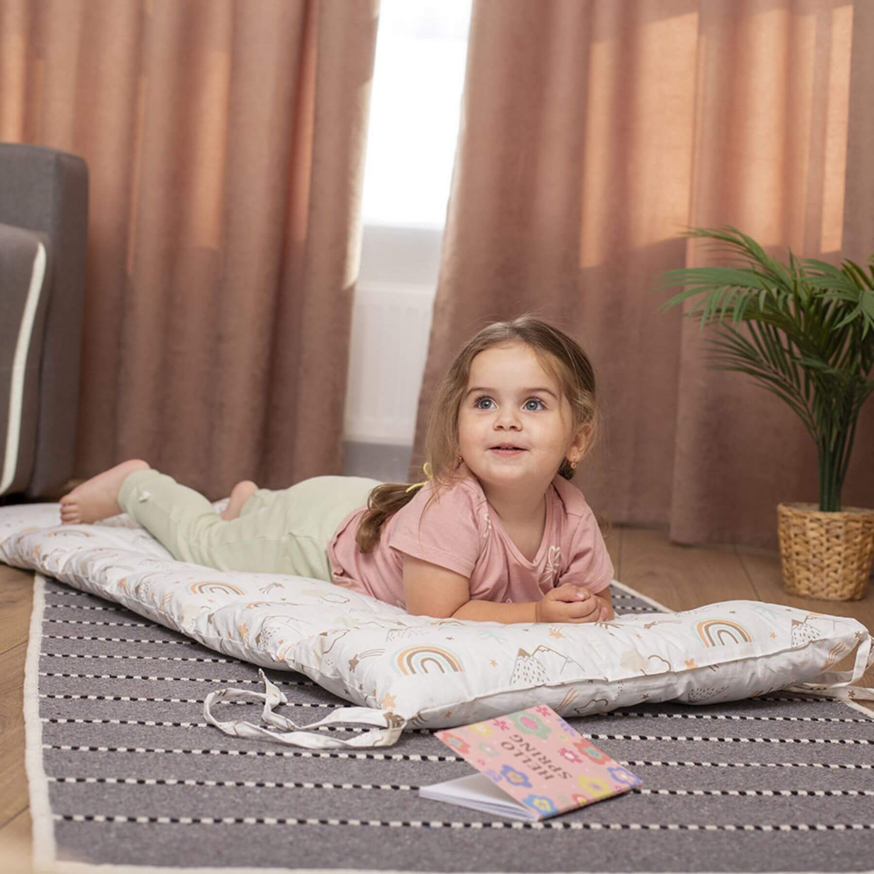 Girl Lying on Wood and Hearts Montessori Rocker Pillow Spring Hiking