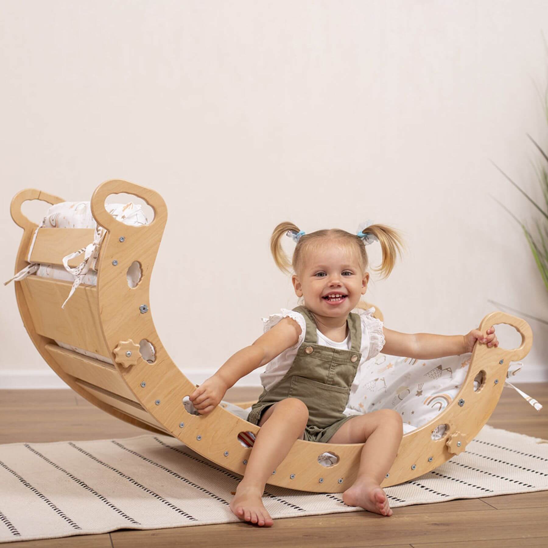 Girl Sitting on Wood and Hearts Montessori Rocker & Pillow Spring Hiking