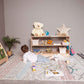 Boy Lying next to Wood and Hearts Montessori Shelf