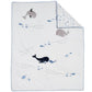 Baby blanket with whale and fish patterns on a white background