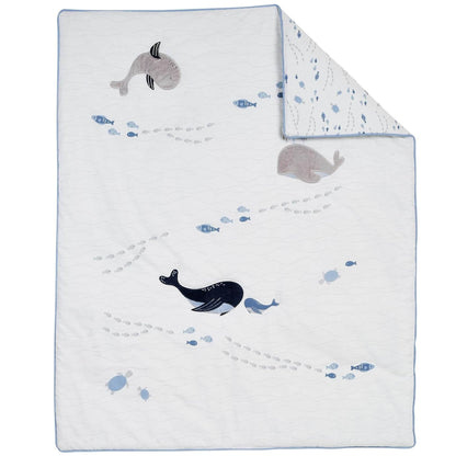 Baby blanket with whale and fish patterns on a white background