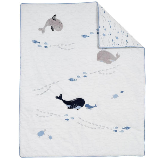 Baby blanket with whale and fish patterns on a white background