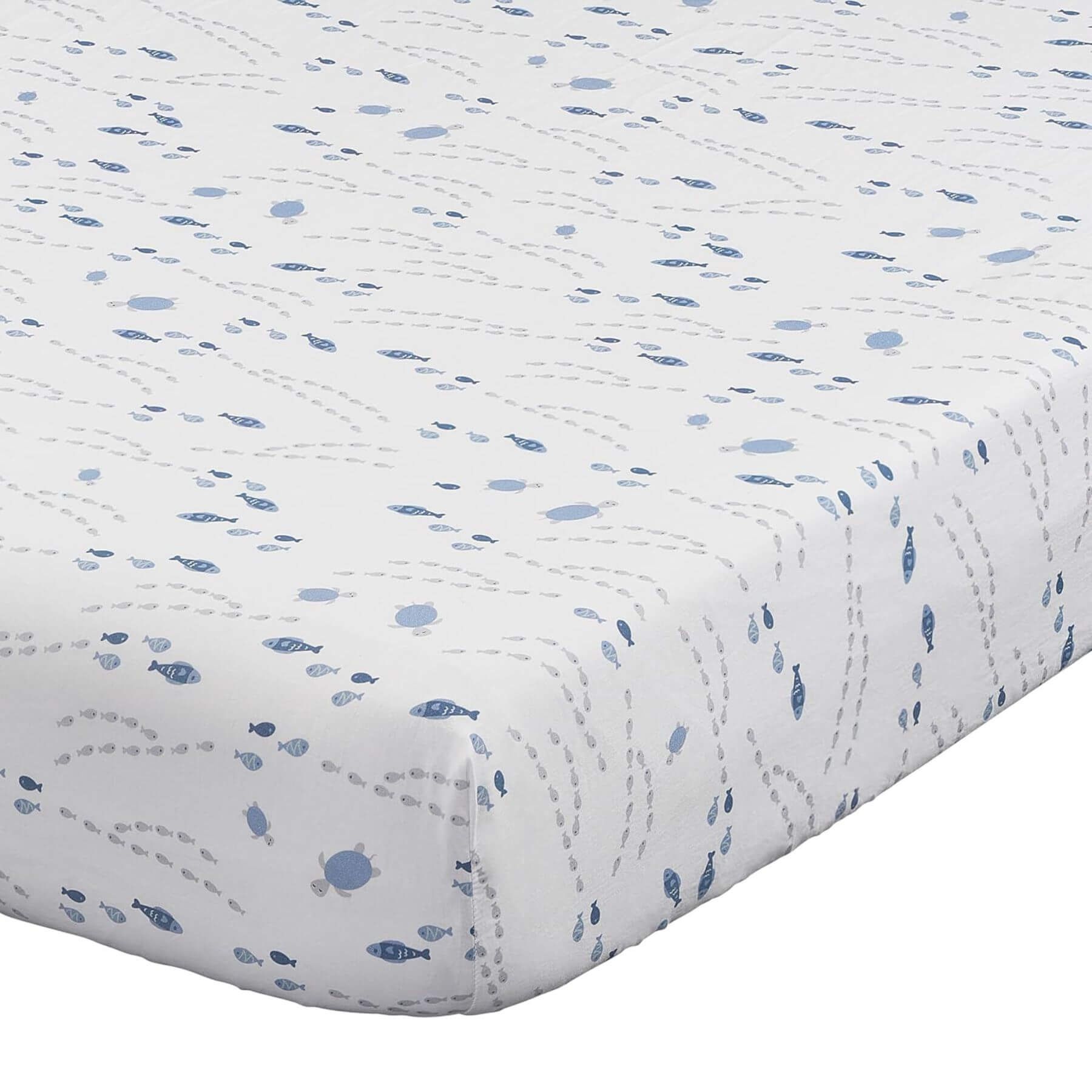 Quilted baby blanket with blue fish pattern on a white background