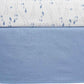 Close-up of a quilt with blue fish pattern on a white background