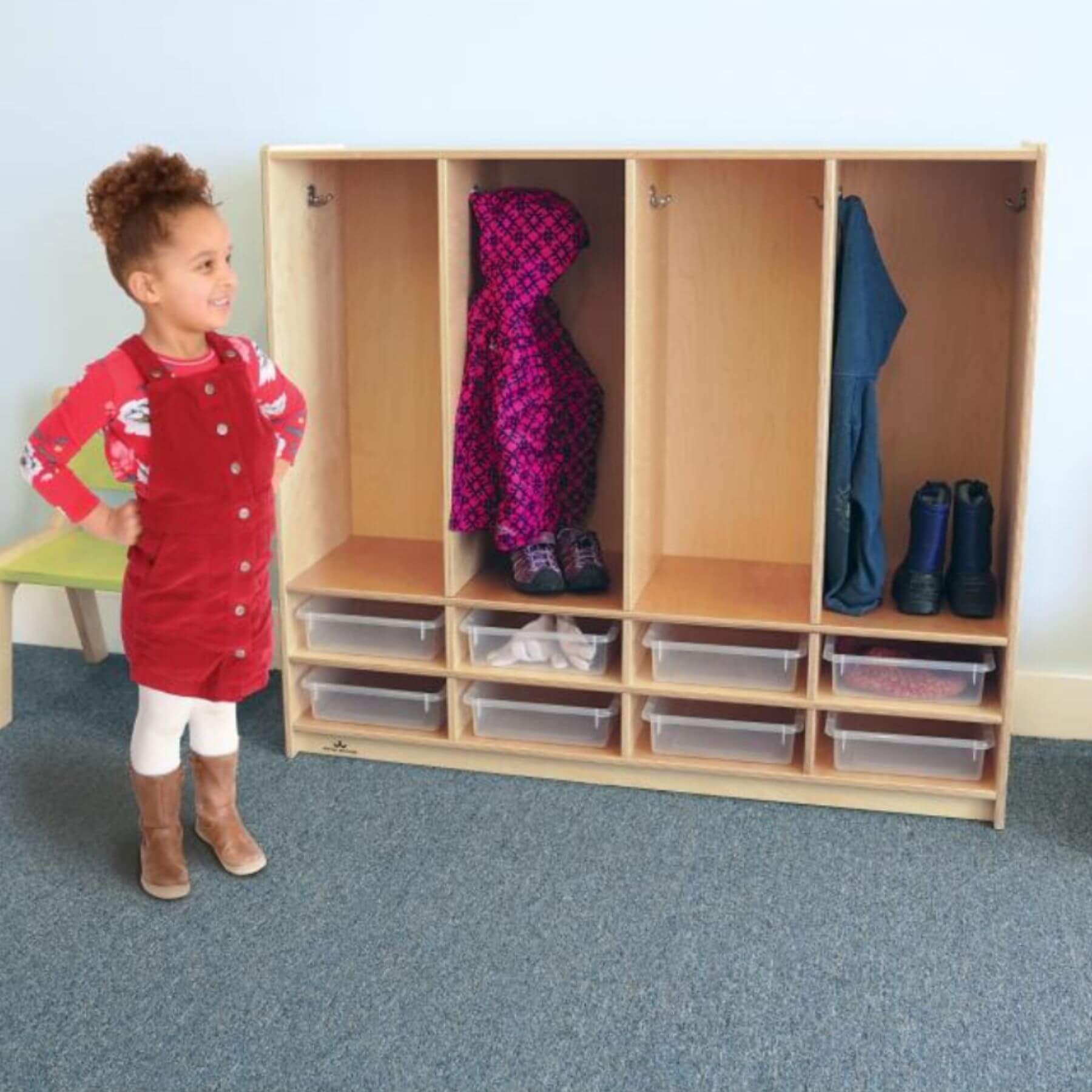 Girl Standing Next to Whitney Brothers Preschool 8 Section Coat Locker With Trays