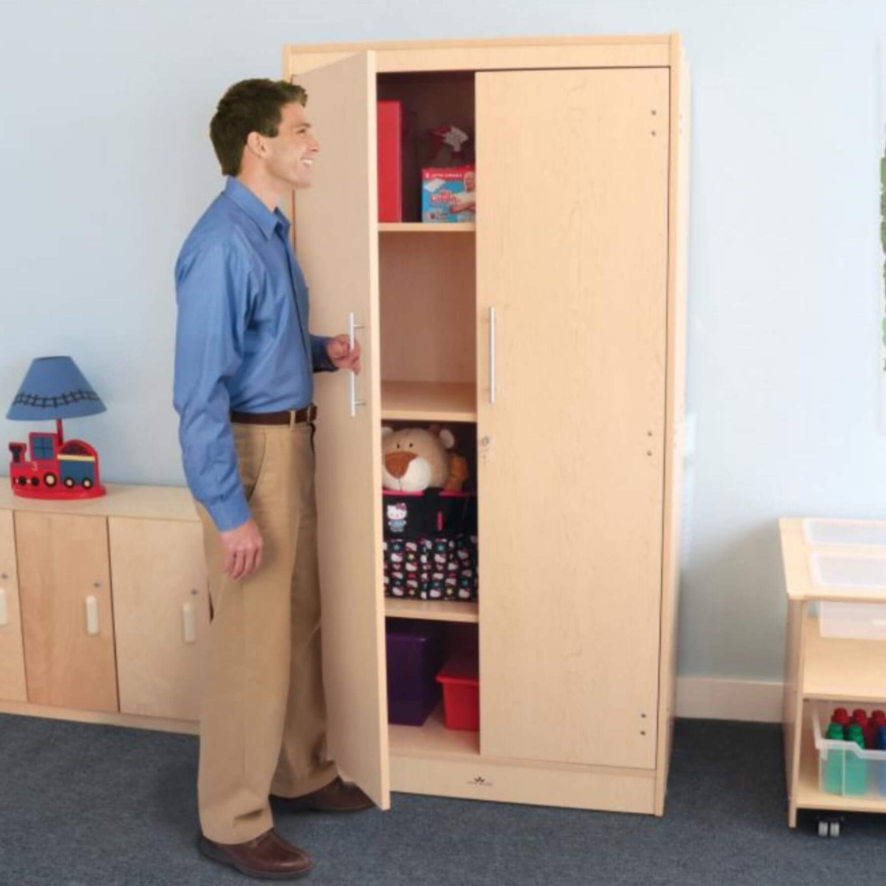 Man Opening Whitney Brothers Tall And Wide Storage Cabinet