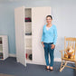 Woman Standing In Front of Whitney Brothers Whitney White Tall And Wide Wall Cabinet