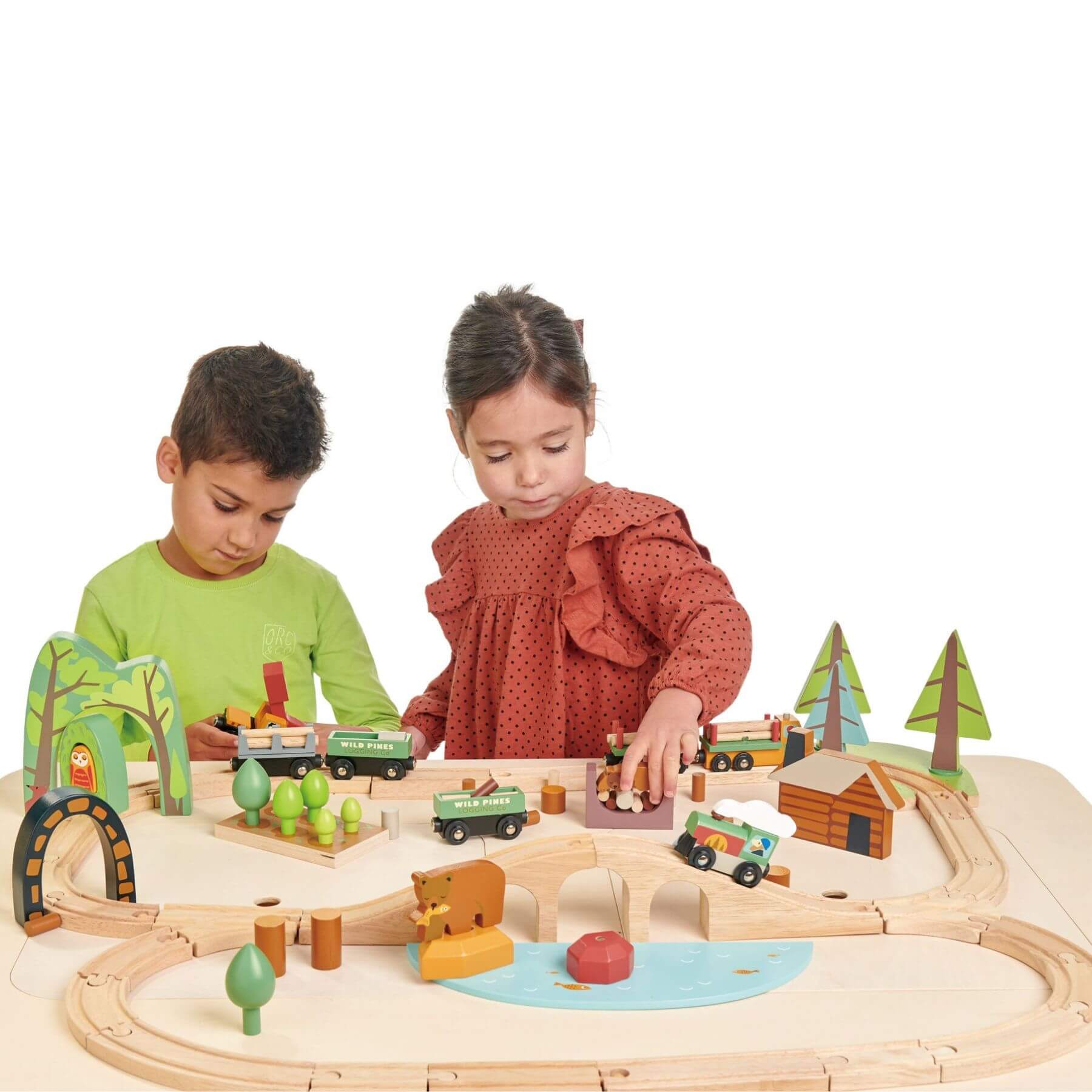 Two children playing with Tender Leaf Wild Pines Train Set