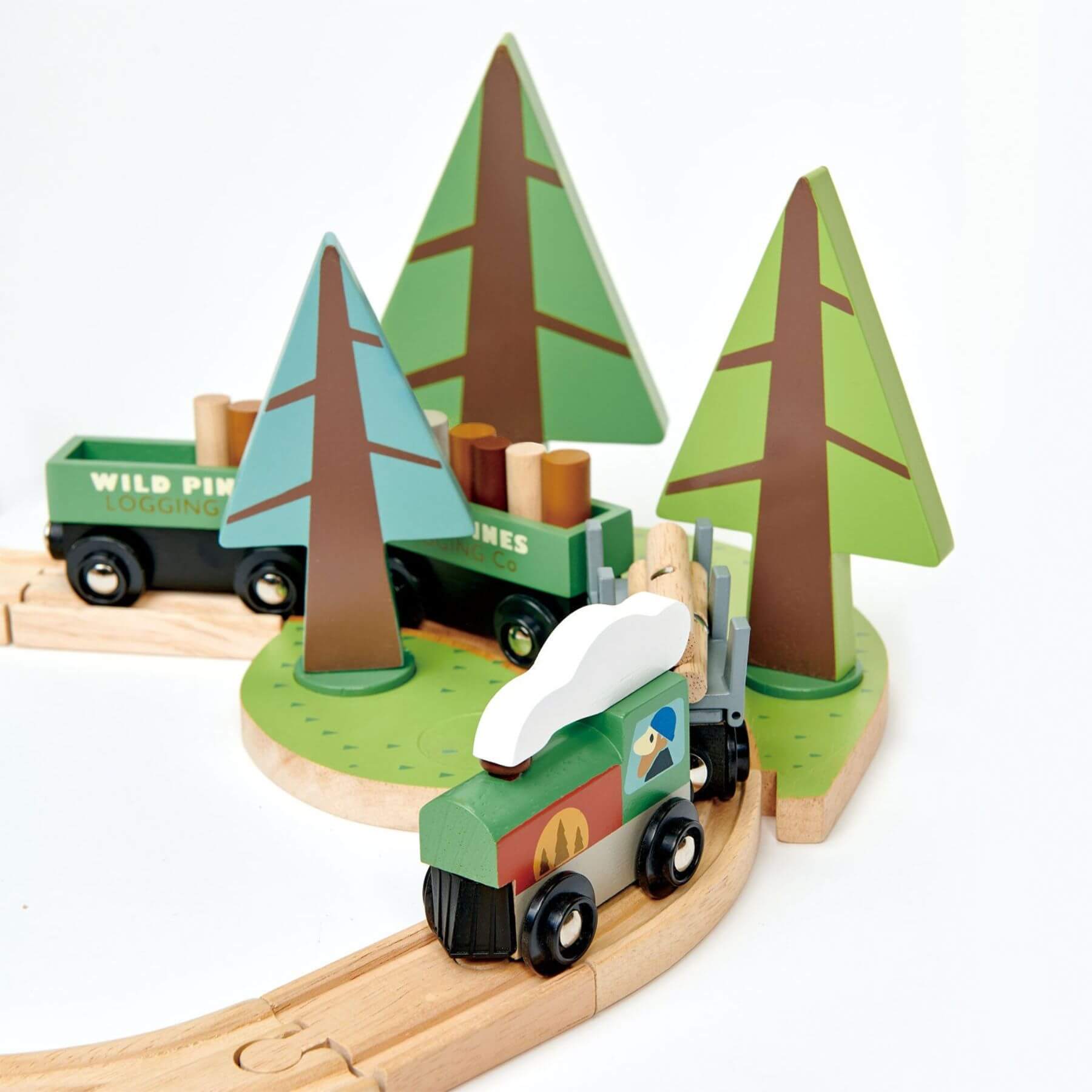 Wooden train set with trees and a truck on a white background