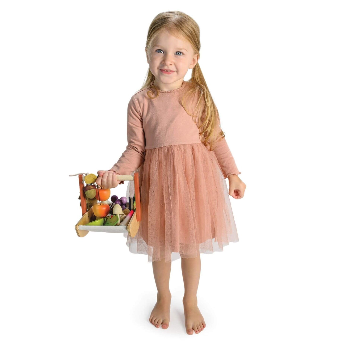 Young girl in a pink dress holding Tender Leaf Wild Wood Foraging Trug